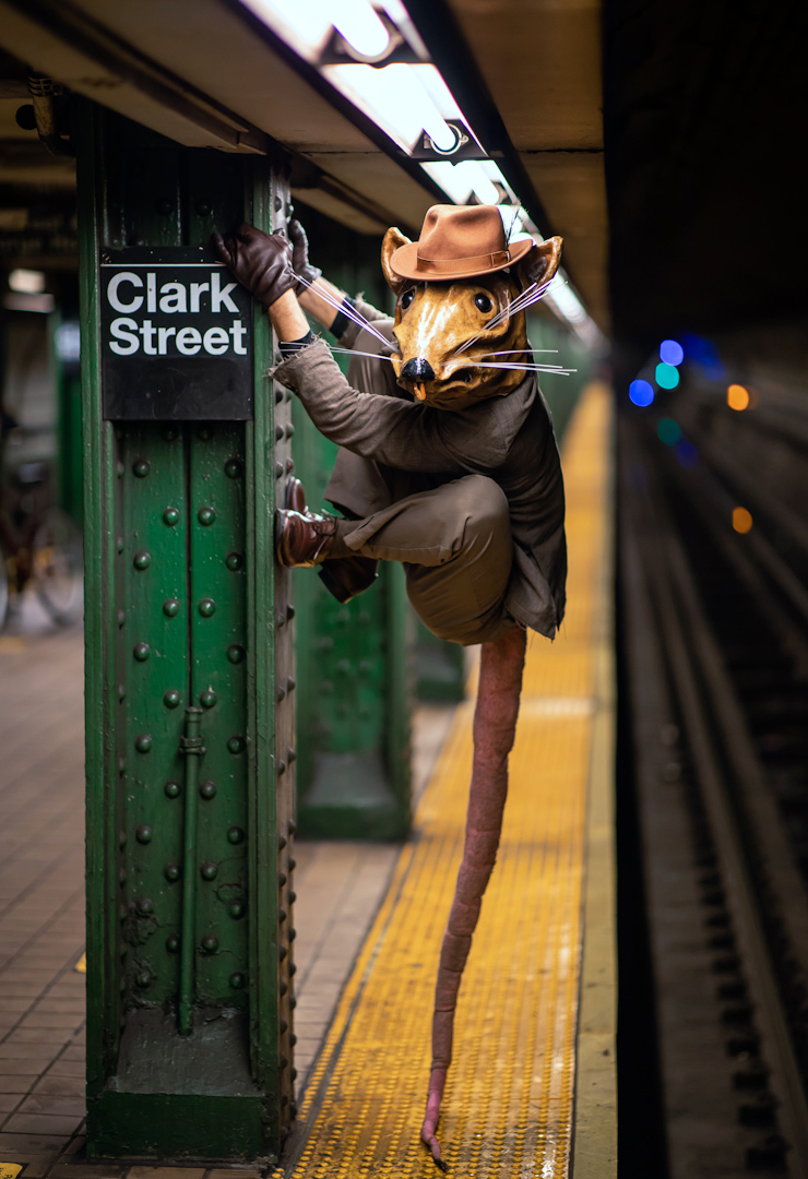 Person with a rat mask in the subway